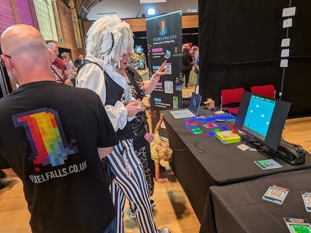 Visitors playing PIXELFALLS demos on prototype hardware at Brighton & Hove Comic Con